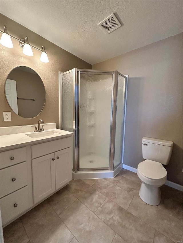 bathroom featuring visible vents, a shower stall, a textured ceiling, and vanity