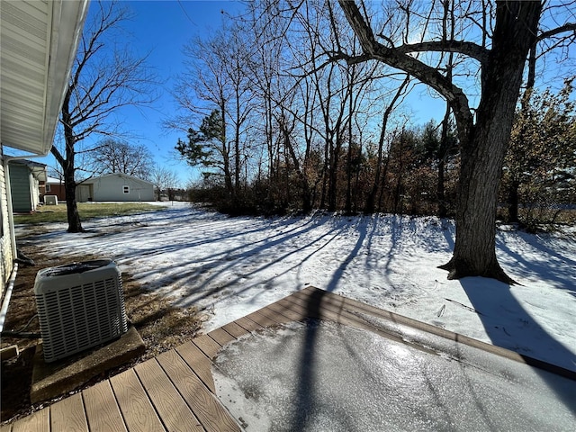 snow covered deck featuring central AC unit