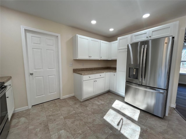 kitchen featuring stainless steel appliances, recessed lighting, white cabinets, and baseboards