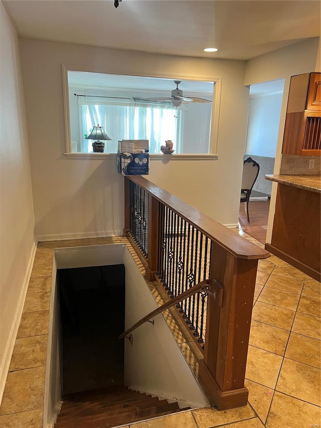 stairs with ceiling fan and tile patterned floors