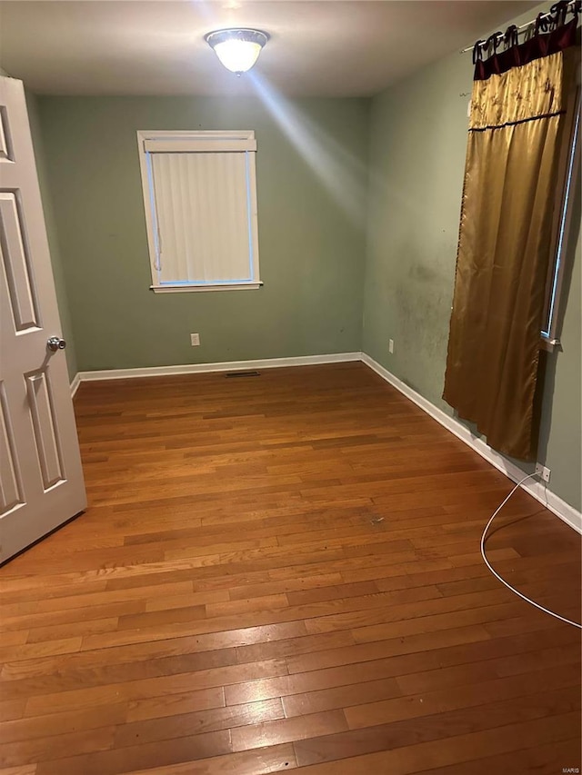 unfurnished bedroom with wood-type flooring