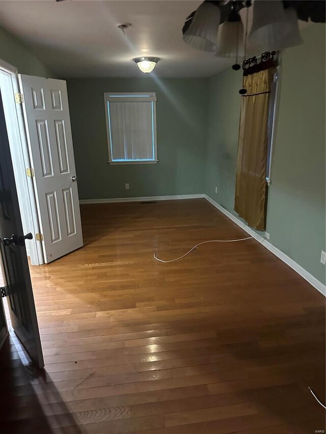 spare room featuring wood-type flooring