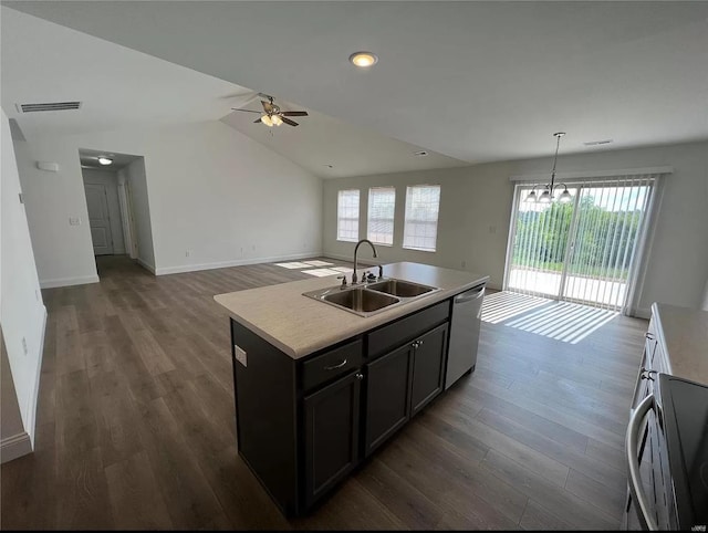 kitchen with decorative light fixtures, a kitchen island with sink, vaulted ceiling, stainless steel dishwasher, and sink