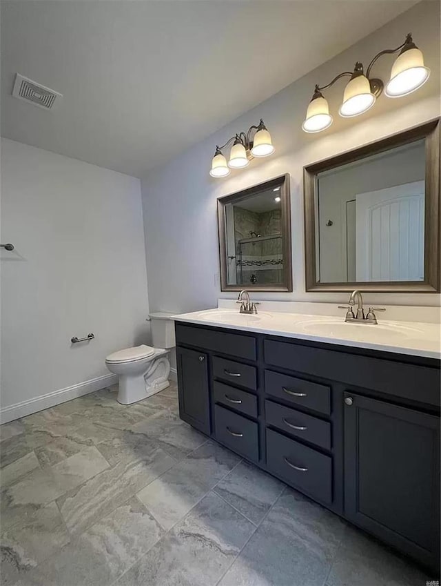 bathroom with toilet and vanity