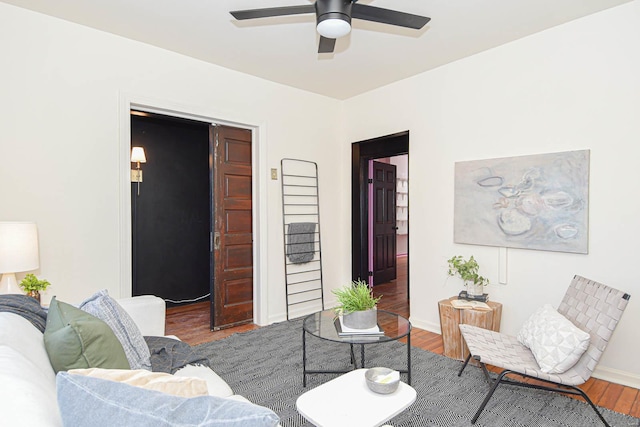 living room featuring hardwood / wood-style floors and ceiling fan