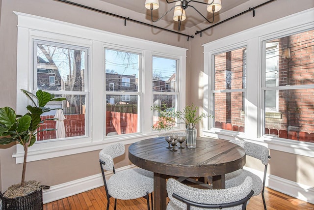 sunroom featuring a wealth of natural light and a chandelier