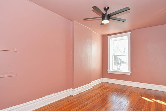 empty room with hardwood / wood-style flooring and ceiling fan