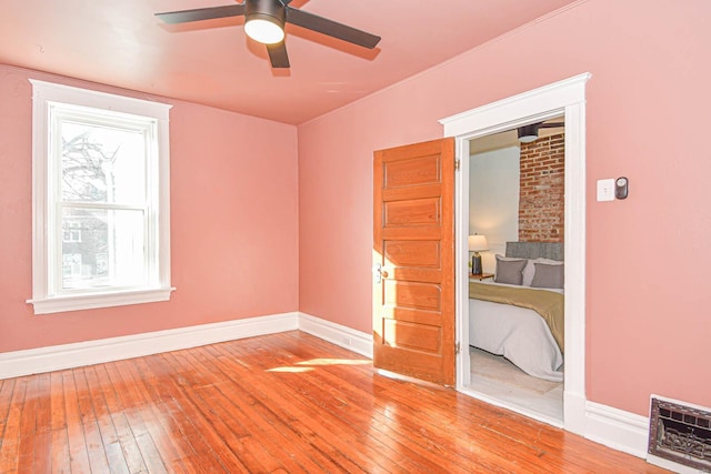 unfurnished bedroom featuring hardwood / wood-style floors and ceiling fan