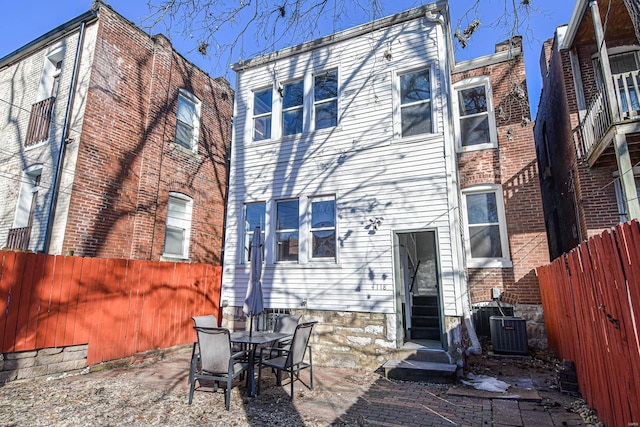 back of property featuring central AC unit and a patio area