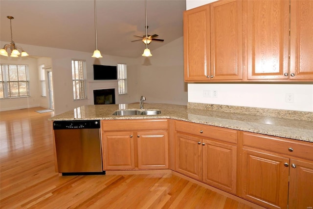 kitchen featuring pendant lighting, light hardwood / wood-style floors, dishwasher, and sink