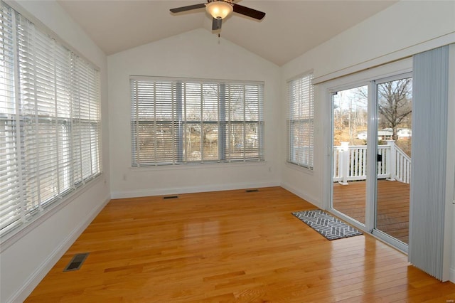 interior space featuring ceiling fan, a healthy amount of sunlight, and vaulted ceiling