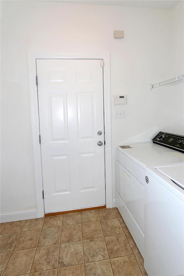 laundry area featuring light tile patterned flooring and washer and dryer