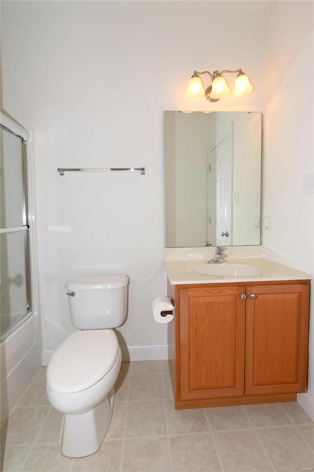 full bathroom with bath / shower combo with glass door, tile patterned floors, toilet, and vanity