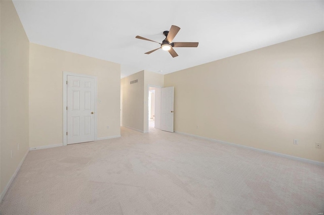 unfurnished room featuring light carpet, baseboards, visible vents, and a ceiling fan