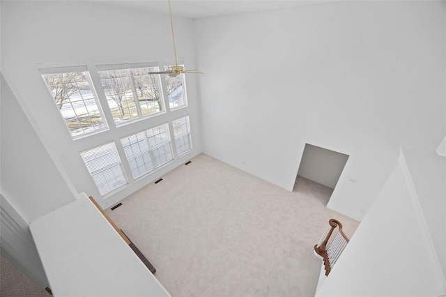 carpeted dining room featuring a towering ceiling and visible vents