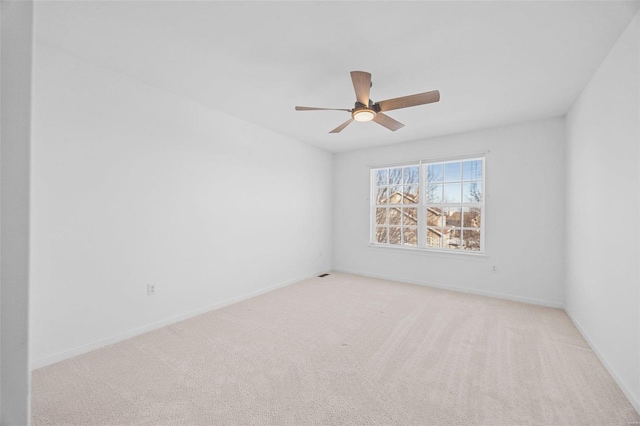 unfurnished room featuring carpet floors, ceiling fan, and baseboards