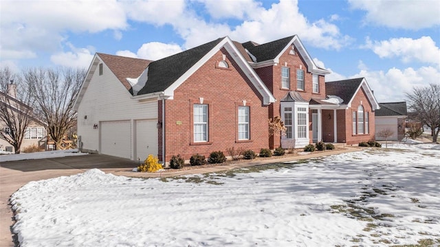 view of front of property featuring brick siding and driveway