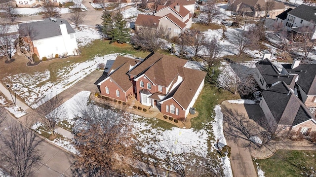 snowy aerial view featuring a residential view