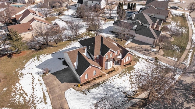 snowy aerial view featuring a residential view