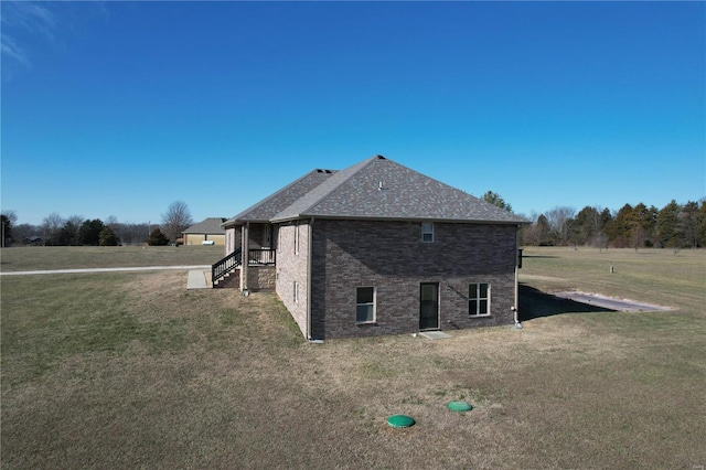 view of side of home with a yard