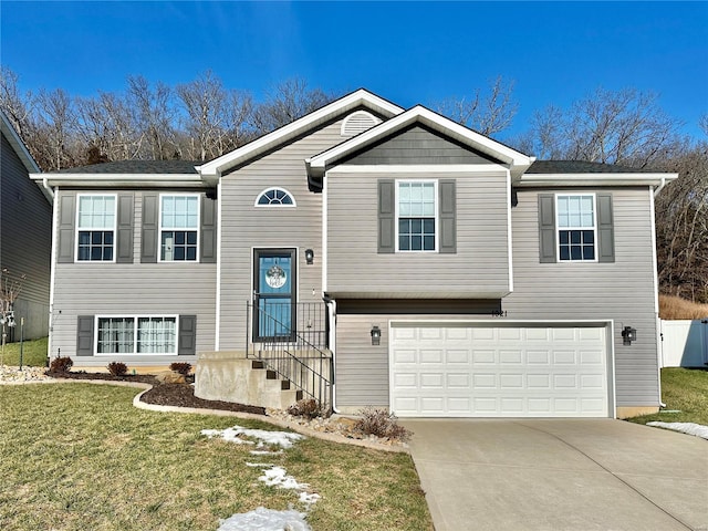 split foyer home with a garage and a front lawn