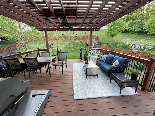 wooden deck with an outdoor living space, a pergola, and a yard