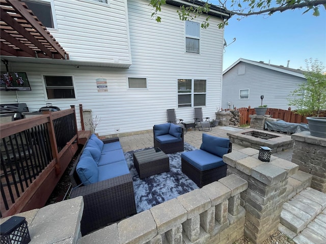 view of patio / terrace with an outdoor living space with a fire pit