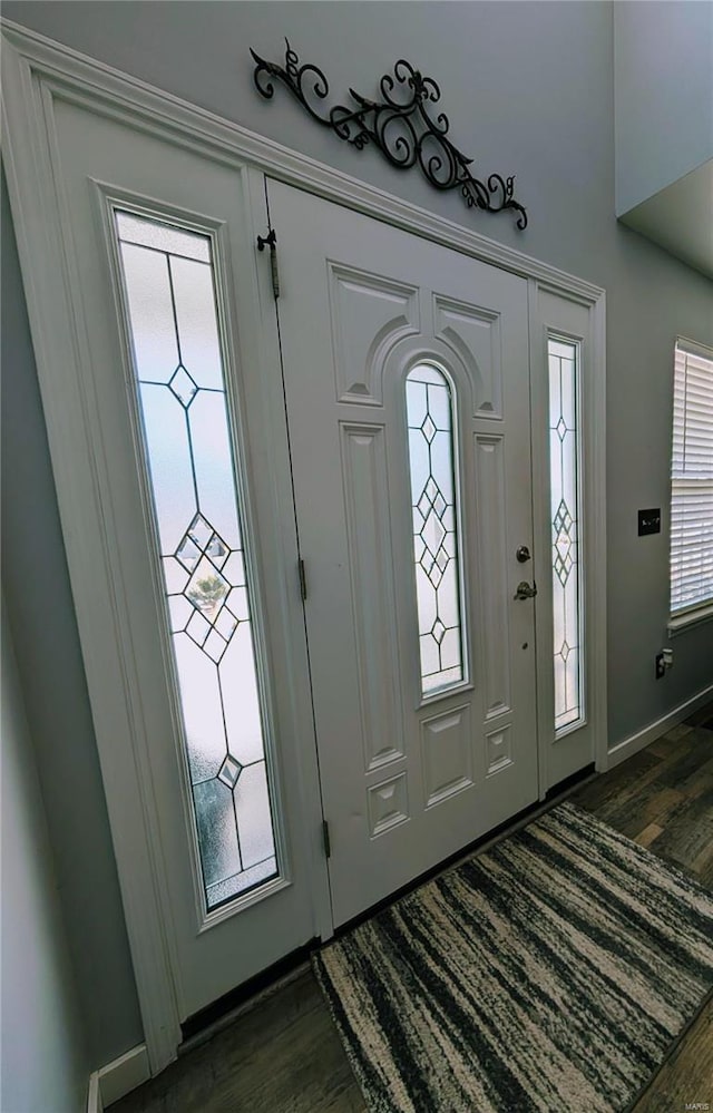 foyer with a wealth of natural light and dark hardwood / wood-style floors