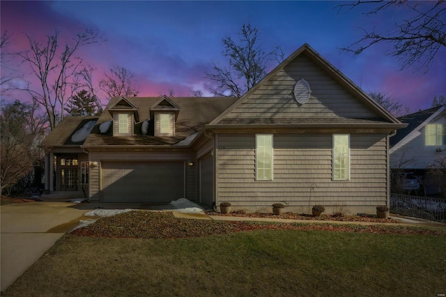 view of front of home featuring a garage and a yard