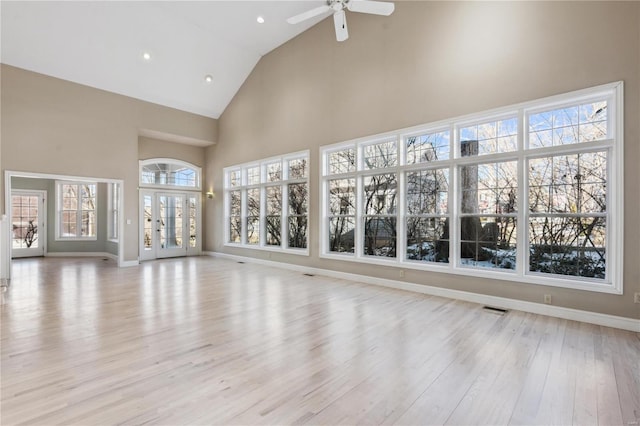 unfurnished living room featuring ceiling fan, high vaulted ceiling, and light hardwood / wood-style flooring