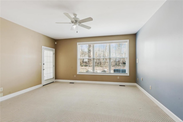 empty room featuring light colored carpet and ceiling fan