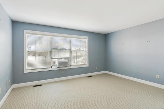 spare room featuring cooling unit and carpet floors