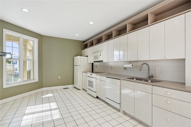 kitchen with tasteful backsplash, sink, white appliances, and white cabinets