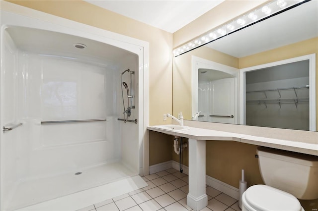 bathroom featuring sink, toilet, tile patterned flooring, and a shower