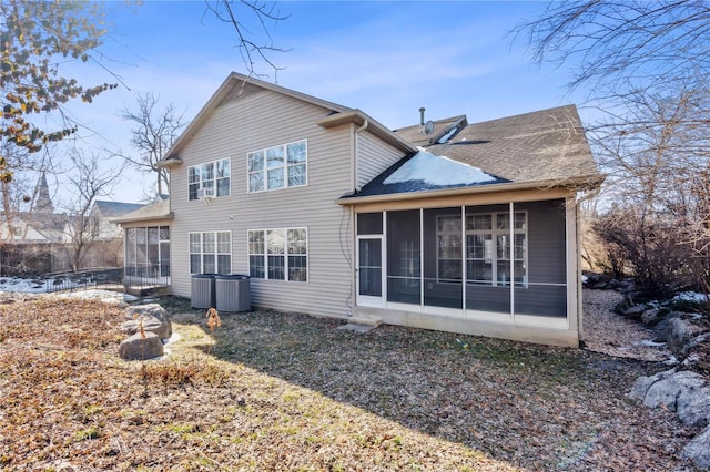 back of property with a sunroom