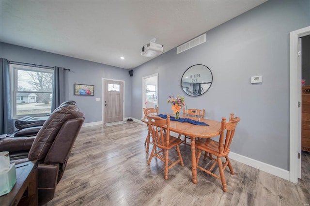 dining area with plenty of natural light and light hardwood / wood-style flooring