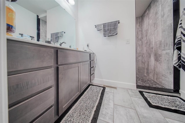 bathroom featuring vanity and a tile shower