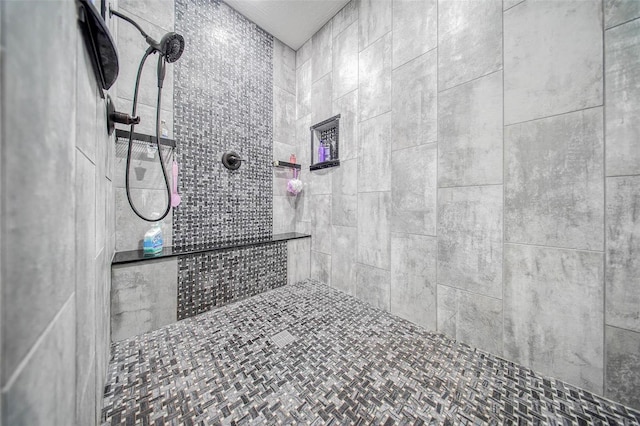 bathroom with tiled shower