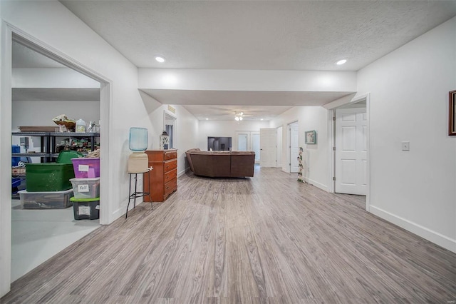 unfurnished living room featuring wood-type flooring and a textured ceiling