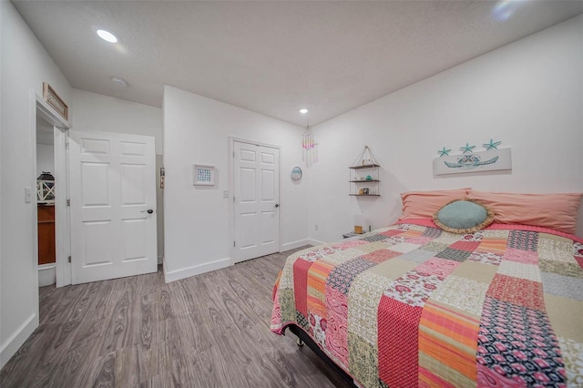 bedroom with wood-type flooring