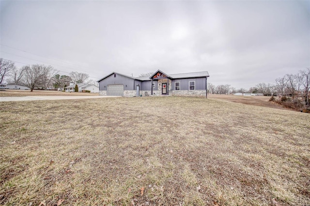 ranch-style house featuring a garage and a front yard