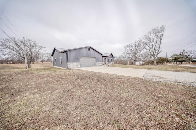 view of property exterior featuring a garage and a yard