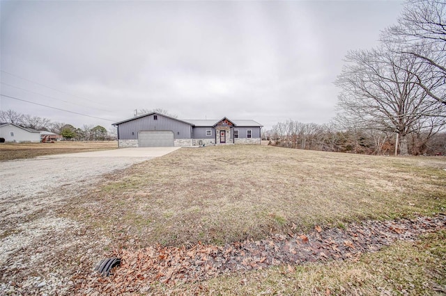 ranch-style house with a garage and a front lawn