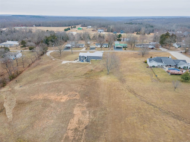 birds eye view of property with a rural view