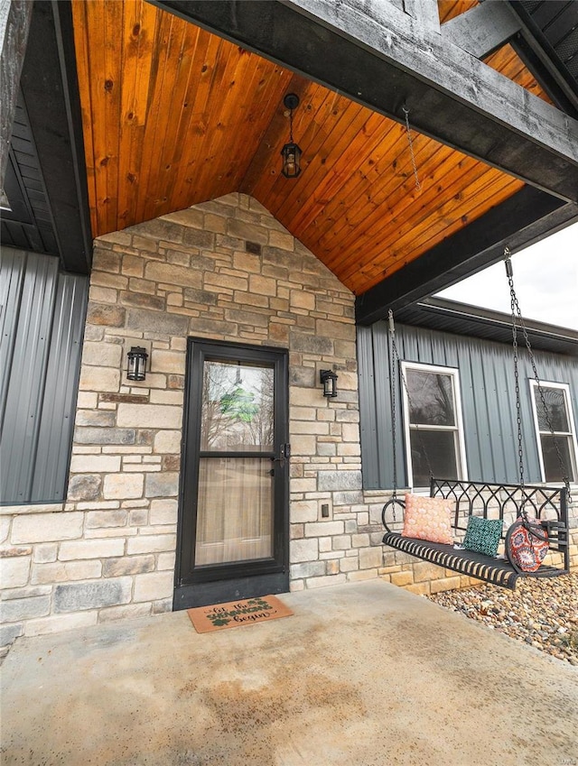 entrance to property featuring stone siding