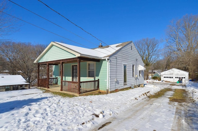 view of front of house featuring an outdoor structure, covered porch, and a garage