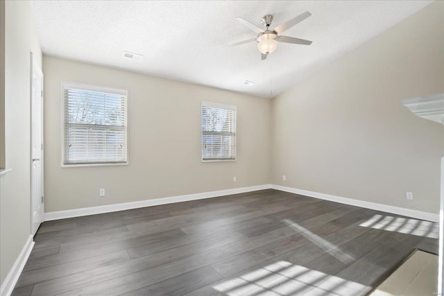 unfurnished room with a textured ceiling, ceiling fan, and dark hardwood / wood-style flooring