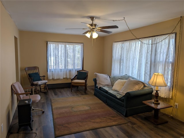 living area featuring dark hardwood / wood-style floors and ceiling fan