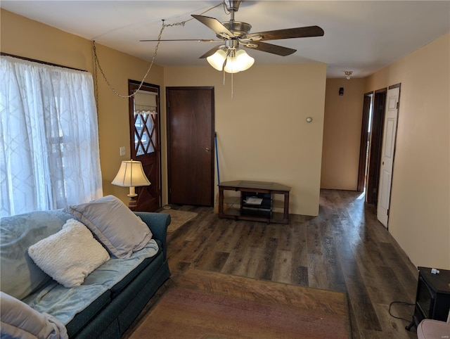 living room with ceiling fan and dark hardwood / wood-style floors