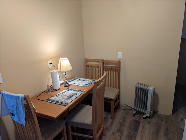 home office featuring dark hardwood / wood-style floors and radiator